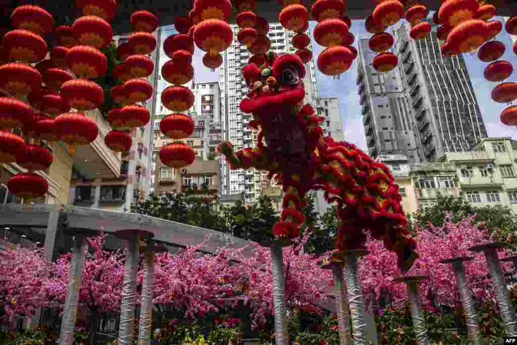 A lion dance team performs to bring good fortune and to chase away bad luck at a shopping district in Hong Kong.