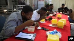 Patrons eat soup joumou at a restaurant in the Delmas district of Port-au-Prince, Haiti, Feb. 5, 2023.
