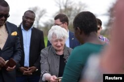 FILE - U.S. Treasury Secretary Janet Yellen purchases locally made honey from beekeeper Mandalena Kambobe in Mwalumina Village, Chongwe, Zambia, Jan. 24, 2023.