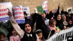 Women shout slogans during a protest outside the Swedish consulate in Istanbul, Turkey, Jan. 22, 2023, condemning a Quran-burning rally in Sweden.