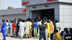 FILE - People line up to withdraw new naira notes at an ATM in Maiduguri, Nigeria, on Jan. 29, 2023. 