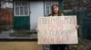 Alina Kapatsyna holds a poster that reads: "Bring back my mom from captivity," written in Ukrainian, in Dnipro, Ukraine, Jan. 6, 2023. Men in military uniforms took 45-year-old Vita Hannych away from her house in eastern Ukraine in April. 