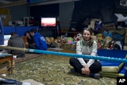 Local residents warm up in a shelter in Bakhmut, Donetsk region, Ukraine, Feb. 10, 2023.