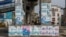 A man sleeps under a bridge decorated with electoral campaign posters, ahead of Nigeria's presidential elections, in Lagos, Nigeria, Jan. 31, 2023.