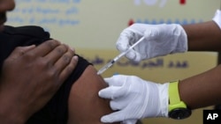 FILE - A man receives the AstraZeneca COVID-19 vaccine at Jabra Hospital in Khartoum, Sudan, March 11, 2021.