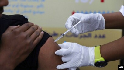 FILE - A man receives a COVID-19 vaccine in Khartoum, Sudan, March 11, 2021. Just a few years after a massive immunization campaign in Brazil, the nation's vaccination rates have plunged — for COVID-19 as well as other diseases.