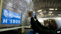 FILE - Workers ready a shipment of relief aid to Gaza at the warehouses of the Jordan Hashemite Charity Organization, sent by UN Relief and Works Agency (UNRWA)