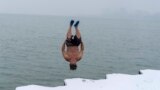 "The Great Lake Jumper" Dan O'Conor takes a plunge into the frigid waters of Lake Michigan, as he does every morning, Thursday, Jan. 26, 2023, in Chicago.(AP Photo/Erin Hooley)