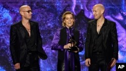 From left, Phil Hanseroth, Brandi Carlile and Tim Hanseroth accept the award for Best rock song for "Broken Horses" at the 65th annual Grammy Awards in Los Angeles, Feb. 5, 2023.