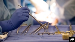 FILE - Surgical instruments are used during an organ transplant surgery at a hospital in Washington on June 28, 2016.