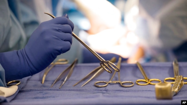 FILE - Surgical instruments are used during an organ transplant surgery at a hospital in Washington on June 28, 2016.