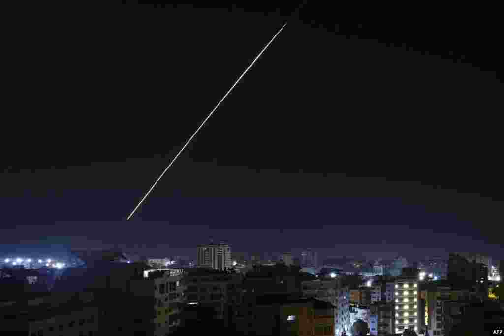 A long exposure shows a light trail from a projectile fired from Gaza City as Israel launched airstrikes on Gaza in response to militant rocket fire from the Palestinian enclave.