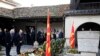 Bulgaria's Interior Minister Ivan Demerdzhiev, left and the health minister Assen Medjidiev, second from left pay bow at the grave of Goce Delcev, a revolutionary who opposed Ottoman rule in the Balkans, Skopje, North Macedonia, Feb. 4, 2023.
