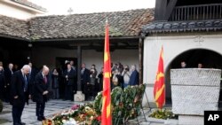 Bulgaria's Interior Minister Ivan Demerdzhiev, left and the health minister Assen Medjidiev, second from left pay bow at the grave of Goce Delcev, a revolutionary who opposed Ottoman rule in the Balkans, Skopje, North Macedonia, Feb. 4, 2023.