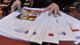 FILE - A worker lays out copies of corruption watchdog Transparency International's annual Corruption Perceptions Index prior to a press conference upon the release of the document, in Berlin, Oct. 26, 2010. 