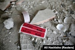 Labels of the Organization for the Prohibition of Chemical Weapons (OPCW) are seen inside a damaged house in Douma on April 23, 2018. (Ali Hashisho/Reuters)