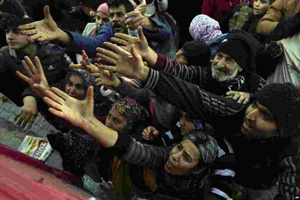 Volunteers distribute aid to people in Antakya, Turkey.&nbsp;Thinly stretched rescue teams worked through the night into Wednesday, pulling more bodies from the rubble of thousands of buildings downed in Turkey and Syria by a catastrophic earthquake.