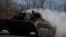 Ukrainian service members ride atop of a BMP-2 infantry fighting vehicle near a frontline in Donetsk region, Ukraine, Feb. 8, 2023.