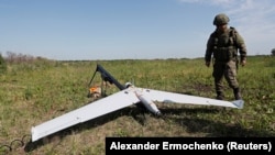 (FILE) A Russian service member prepares a UAV for launch in Ukraine.