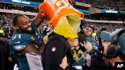 Philadelphia Eagles head coach Nick Sirianni, center, is doused by defensive tackle Fletcher Cox (91) and teammates during the second half of the NFC Championship NFL football game between the Philadelphia Eagles and the San Francisco 49ers on Jan. 29, 2023, in Philadelphia.