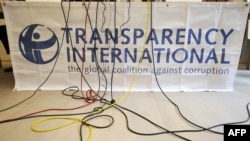 FILE - Microphone cables dangle over the logo of Transparency International during a press conference in Berlin, Sept. 23, 2008. The organization released its annual report on Jan. 30, 2024, showing that Denmark is the least-corrupt nation and Somalia the most.