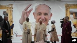 Pope Francis meets a displaced girl during a meeting with internally displaced persons in the "Freedom Hall" in Juba, South Sudan, Saturday, Feb. 4, 2023.