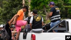 Police detain anti-government protesters at San Marcos University in Lima, Peru, Jan. 21, 2023.