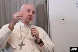 Pope Francis addresses the media while aboard the plane from Juba to Rome on February 5, 2023 returning from he Pope's visit to Democratic Republic of Congo and South Sudan. (Photo by Tiziana Fabi / Pool/AFP)