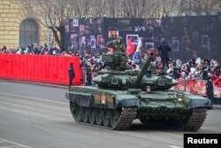 Russian service members drive a tank during a military parade marking the 80th anniversary of the victory of Red Army over Nazi Germany's troops in the Battle of Stalingrad during World War II, in Volgograd, Russia, Feb. 2, 2023.