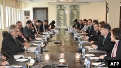 FILE - This handout photograph released by the Pakistan Press Information Department (PID) on Jan. 31, 2023, shows Pakistani and International Monetary Fund officials meeting at the Finance Ministry in Islamabad.