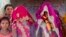 FILE - In this April 17, 2017, photo, an underaged bride, right, stands with family members during her marriage at a Hindu temple near Rajgarh, Madhya Pradesh state, India.