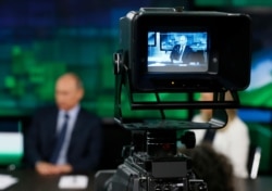 FILE - Russian President Vladimir Putin is seen on the screen of a camera viewfinder in a studio of Russia's RT television channel in Moscow, Russia, June 11, 2013.