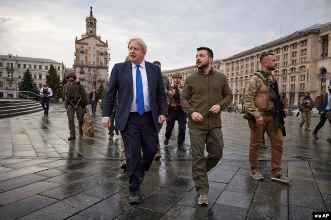 FILE - In this image provided by the Ukrainian Presidential Press Office, Ukrainian President Volodymyr Zelenskyy, center right, and Britain's Prime Minister Boris Johnson walk during Johnson's visit, in downtown Kyiv, Ukraine, Apr. 9, 2022.