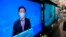 TV screens show Hong Kong's number two official, John Lee, speaking during an online press conference to announce his candidacy for the election of Hong Kong chief executive, in Hong Kong, April 9, 2022.
