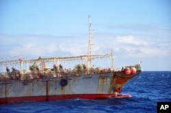 FILE - The Chinese squid fishing vessel Fu Yuan Yu 7880 sails on the Pacific Ocean on July 18, 2021. The Pingtan-affiliated vessel was arrested by South Africa in 2016 after it tried to flee a naval patrol that suspected it of illegal squid fishing.