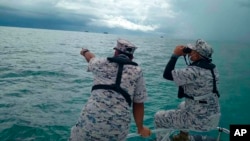 This photo released by the Malaysian Maritime Enforcement Agency (MMEA) on April 8, 2022, shows a search and rescue operation for foreign divers off the coast of Johor's Mersing, Malaysia.