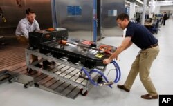 In this Nov. 4, 2016, file photo, a Chevrolet Bolt EV battery pack is removed for testing after undergoing charging and discharging cycles at General Motors Warren Technical Center's Advanced Energy Center in Warren, Mich. (AP Photo/Duane Burleson, File)