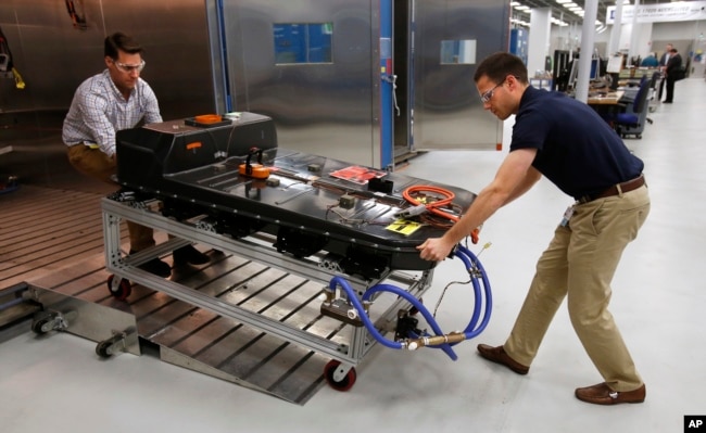 In this Nov. 4, 2016, file photo, a Chevrolet Bolt EV battery pack is removed for testing after undergoing charging and discharging cycles at General Motors Warren Technical Center's Advanced Energy Center in Warren, Mich. (AP Photo/Duane Burleson, File)