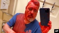 In this photo published on Novaya Gazeta Europe's Telegram channel, Nobel Peace Prize-winning newspaper editor Dmitry Muratov takes a selfie after he said he was attacked on a Russian train by an assailant who poured red paint on him, in Russia, April 7, 2022.