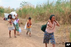 FILE - Displaced people from Myanmar along the Thai side of the Moei River in Mae Sot, Thailand on Feb. 5, 2022. (AP Photo)