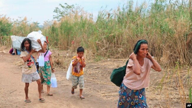 Displaced people from Myanmar along the Thai side of the Moei River in Mae Sot, Thailand on Feb. 5, 2022. (AP Photo)