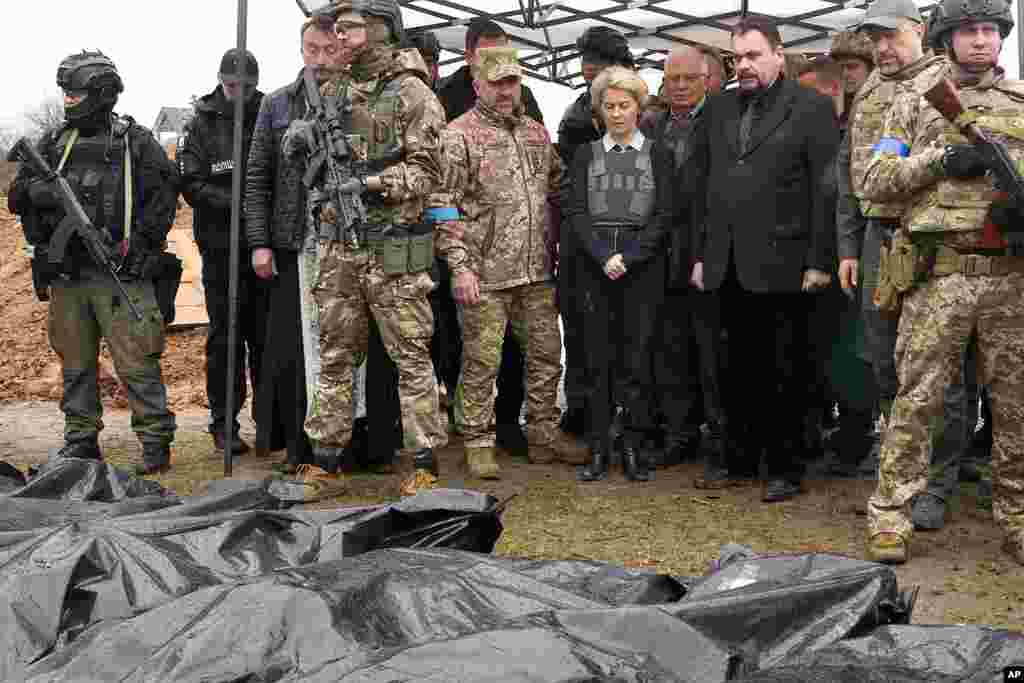 EU Commission President Ursula von der Leyen, center, looks at covered bodies of killed civilians in Bucha, on the outskirts of Kyiv, Ukraine.
