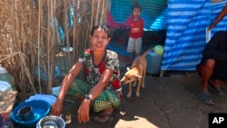 Displaced people from Myanmar live under a makeshift tent along the Thai side of the Moei River in Mae Sot, Thailand on Feb. 7, 2022.