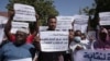 FILE - Sudanese journalists protest in Khartoum, Sudan, Nov.16, 2021. Many of the placards read: "We stand with the masses against the military coup." 