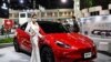 Un modèle fait la promotion de la voiture électrique Tesla Model Y au salon international de l'automobile de Bangkok le 24 mars 2022.