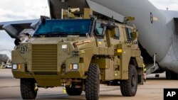 In this photo provided by the Australian Defense Force, a Bushmaster protected mobility vehicle bound for Ukraine waits to be loaded onto a C-17A Globemaster III aircraft at RAAF Base Amberley, Australia, Thursday, April 7, 2022. 