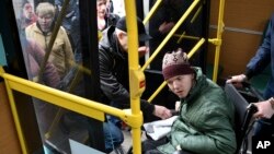 People board transportation during evacuation of civilians in Kramatorsk, Ukraine, April 10, 2022. 