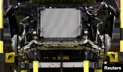 In this file photo, a battery cell is shown being installed at a Mercedes-Benz EQC electric car in a production line at a plant in Bremen, Germany, January 29, 2020. (REUTERS/Fabian Bimmer)