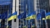 FILE - The flags of the European Union and Ukraine flutter outside the European Parliament building, in Brussels, Belgium, Feb. 28, 2022. Hungary said on Nov. 30, 2023, that it is premature for the European Union to begin talks on making Ukraine a member of the bloc.