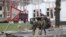 Ukrainian troops patrol Borodyanka, Ukraine, days after retaking the town from Russian soldiers, April 6, 2022. (Heather Murdock/VOA)

